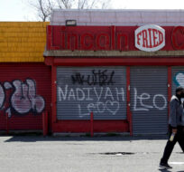 In this April 26, 2018, photo a man walks by a closed restaurant along Bergen Street in a so-called "opportunity zone" in Newark, N.J. About 8,700 opportunity zones have been set up in all 50 states and to lure investors and developers with tax breaks. Julio Cortez/AP Photo.