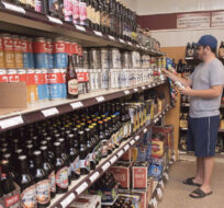 Customer Matt Oliver shops in the craft beer section of the NB Liquor store attached to the old Fredericton Railway Station in Fredericton, N.B., on Friday, June 16, 2017. Stephen MacGillivray/The Canadian Press. 