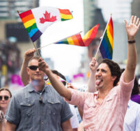 Prime Minister Justin Trudeau waves a flag as he takes part in the annual Pride Parade in Toronto on Sunday, July 3, 2016. Nathan Denette/The Canadian Press. 