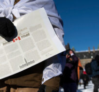 A person holds a copy of the Canadian Charter of Rights and Freedoms in Ottawa, on Saturday, Jan. 29, 2022. Justin Tang/The Canadian Press. 