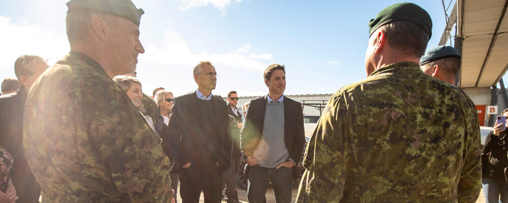 NATO Secretary General Jens Stoltenberg and Prime Minister Justin Trudeau speak with military personnel about the North Warning System Site in Cambridge Bay, Nunavut, on Thursday August 25, 2022. Jason Franson/The Canadian Press. 