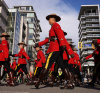 RCMP officers in red serge march in Richmond, B.C., on November 2, 2022. Darryl Dyck/The Canadian Press.