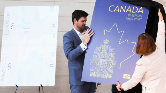 Sean Fraser, Minister of Immigration, Refugees and Citizenship, and Marie-France Lalonde, Parliamentary Secretary to the Minister of Immigration, Refugees and Citizenship unveil the new Canadian passport at the Ottawa International Airport in Ottawa on Wednesday, May 10, 2023. Sean Kilpatrick/The Canadian Press. 