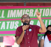 Syed Hussan, executive director of Migrant Workers Alliance for Change, speaks to a crowd gathered in front of Immigration Minister Marco Mendicino's office in Toronto, Saturday, July 4, 2020. Galit Rodan/The Canadian Press. 