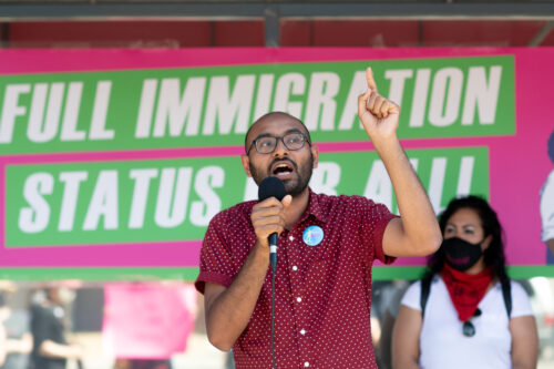 Syed Hussan, executive director of Migrant Workers Alliance for Change, speaks to a crowd gathered in front of Immigration Minister Marco Mendicino's office in Toronto, Saturday, July 4, 2020. Galit Rodan/The Canadian Press. 