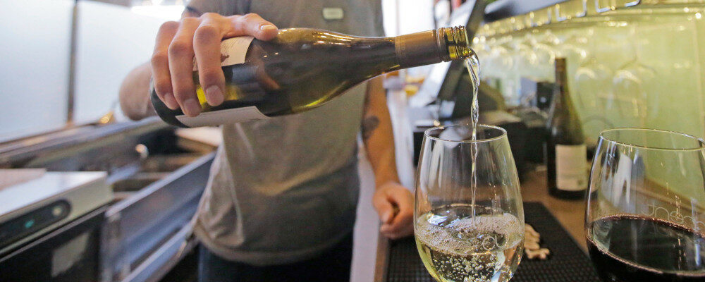 This Wednesday, March 29, 2017, photo, Current Fish & Oyster Restaurant bartender Wren Kennedy pours wine behind the bar, in Salt Lake City. Rick Bowmer/AP Photo.