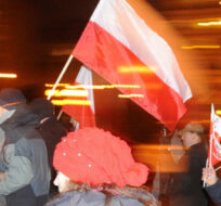 Supporters of Poland's main opposition party,  Law and Justice, march through the downtown in Warsaw, Poland, Thursday, Dec. 13, 2012,  to commemorate the 31st anniversary of a communist crackdown and to express grievances with the current democratic system. Alik Keplicz/AP Photo.