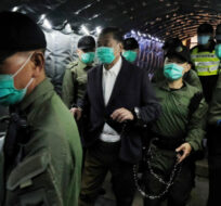 Hong Kong pro-democracy activist and media tycoon Jimmy Lai, center left, is escorted by Correctional Services officers to get on a prison van at the Court of Final Appeal in Hong Kong, Thursday, Dec. 31, 2020. AP Photo.