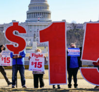 Activists appeal for a $15 minimum wage near the Capitol in Washington, Thursday, Feb. 25, 2021. J. Scott Applewhite/AP Photo. 
