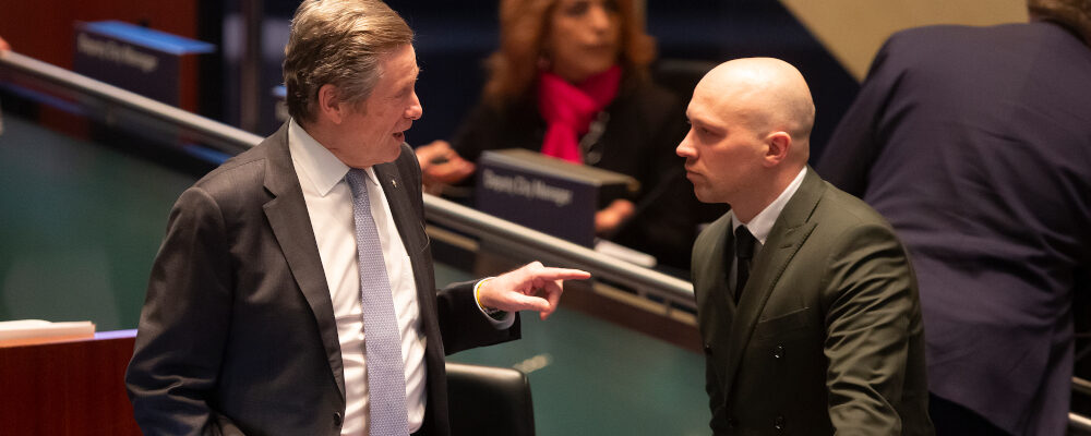 Mayor John Tory (left) talks to councillor Brad Bradford in the council chamber ahead of a budget meeting in Toronto,  on Wednesday, February 15, 2023. Chris Young/The Canadian Press. 