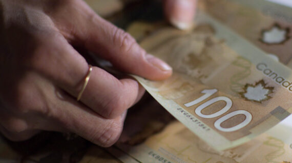 Canadian $100 bills are counted in Toronto in a Feb. 2, 2016 file photo. Graeme Roy/The Canadian Press. 