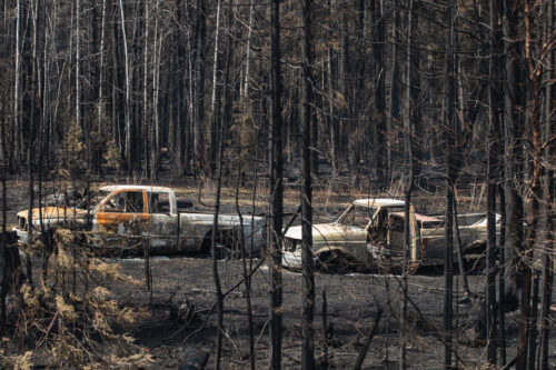 Burnt out trucks from a wildfire sit on a property near Drayton Valley, Alta., Wednesday, May 10, 2023. Jason Franson/The Canadian Press. 