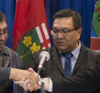 Ontario Premier Doug Ford shakes hands with Chief Cornelius, Wabasse Webequie First Nation, left, and Chief Bruce Achneepineskum, Marten Falls First Nation, centre, after signing a new deal in the ring of fire in Northern Ontario at the Prospectors and Developers Association of Canada's annual convention in Toronto on Monday, March 2, 2020. Nathan Denette/The Canadian Press. 