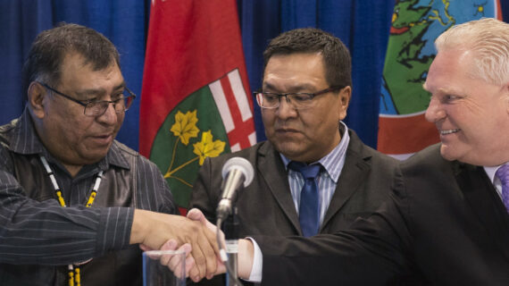Ontario Premier Doug Ford shakes hands with Chief Cornelius, Wabasse Webequie First Nation, left, and Chief Bruce Achneepineskum, Marten Falls First Nation, centre, after signing a new deal in the ring of fire in Northern Ontario at the Prospectors and Developers Association of Canada's annual convention in Toronto on Monday, March 2, 2020. Nathan Denette/The Canadian Press. 