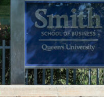 A person walks by the Smith School of Business at Queen's University in Kingston, Ont., Friday, Aug. 14, 2020. Lars Hagberg/The Canadian Press. 