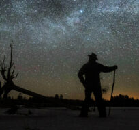 Stargazer Dave Cooke observes an unusual placement of the Milky Way, over a frozen fish sanctuary in central Ontario, north of Hwy 36 in Kawartha Lakes, Ont., on Sunday, March 21, 2021. Fred Thornhill/The Canadian Press. 