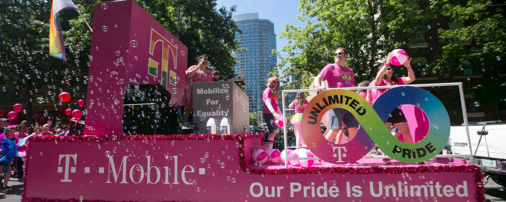 Employees from T-Mobile, the presenting sponsor for Seattle Pride, on the company's float on Sunday June 24, 2018. Ron Wurzer/AP Images for T-Mobile.