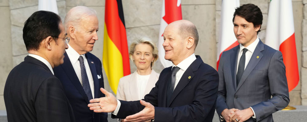 Prime Minister Justin Trudeau and U.S. President Joe Biden look on as German Chancellor Olaf Scholz gestures to Japan's Prime Minister Fumio Kishida as they arrive to take part in a G7 family photo at NATO headquarters in Brussels, Belgium on Thursday, March 24, 2022. Sean Kilpatrick/The Canadian Press. 