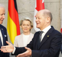 Prime Minister Justin Trudeau and U.S. President Joe Biden look on as German Chancellor Olaf Scholz gestures to Japan's Prime Minister Fumio Kishida as they arrive to take part in a G7 family photo at NATO headquarters in Brussels, Belgium on Thursday, March 24, 2022. Sean Kilpatrick/The Canadian Press. 