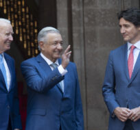 Mexican President Andres Manuel Lopez Obrador waves as he poses with United States President Joe Biden and Prime Minister Justin Trudeau for an official photo at the North American Leaders Summit on Jan. 10, 2023 in Mexico City, Mexico. Adrian Wyld/The Canadian Press.