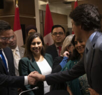 Prime Minister Justin Trudeau shakes hands with Conservative leader Pierre Poilievre as he leaves a Tamil heritage month reception on January 30, 2023 in Ottawa. Adrian Wyld/The Canadian Press.