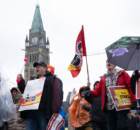 Public Service Alliance of Canada (PSAC) striking government workers walk a picket line around the front lawn of Parliament Hill, in Ottawa, Wednesday, April 26, 2023. Adrian Wyld/The Canadian Press. 