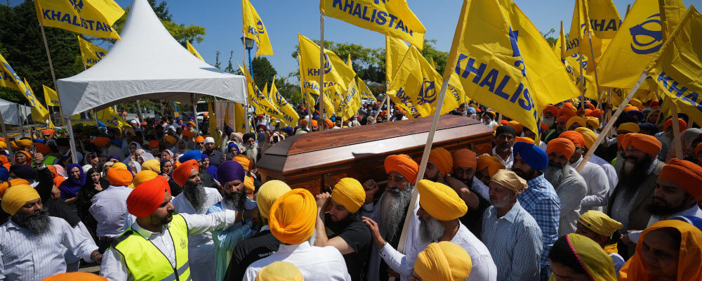 Mourners carry the casket of Sikh community leader and temple president Hardeep Singh Nijjar in Surrey, B.C., Sunday, June 25, 2023. Darryl Dyck/The Canadian Press.