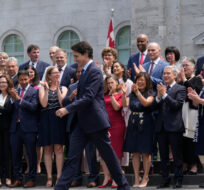 Prime Minister Justin Trudeau walks to a group photo opportunity with his new cabinet following a swearing-in ceremony at Rideau Hall in Ottawa on Wednesday, July 26, 2023. Adrian Wyld/The Canadian Press. 