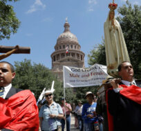 Cesar Franco, left, and Zecharia Long, right, lead members of American Society for the Defense of Tradition, Family, Property , a group supporting the Texas 'bathroom bill', in procession following a prayer rally on the steps of the Texas Capitol, Tuesday, Aug. 15, 2017, in Austin. Eric Gay/AP Photo. 