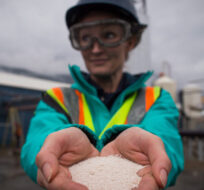 Senior process engineer Jane Ritchie holds solid calcium carbonate pellets that were formed by precipitating captured carbon dioxide at Calgary-based Carbon Engineering's first direct air capture plant in Squamish, B.C., on Wednesday October 7, 2015. Darryl Dyck/The Canadian Press. 