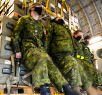 Royal Canadian Air Force personnel load non-lethal and lethal military aid at CFB Trenton, Ontario on Monday, March 7, 2022. Sean Kilpatrick/The Canadian Press. 