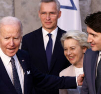 From left, Japan's Prime Minister Fumio Kishida, U.S. President Joe Biden, NATO Secretary General Jens Stoltenberg, European Commission President Ursula von der Leyen, Canada's Prime Minister Justin Trudeau and Germany's Chancellor Olaf Scholz befor  the G7 leaders' group photo during a NATO summit in Brussels, Thursday March 24, 2022. Henry Nicholls/Pool via AP.