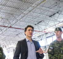 From left, General Steve Graham, Prime Minister Justin Trudeau and Colonel Ben Schmidt and Mp Bill Blair discuss the Alberta wildfires while meeting with members of the Canadian Armed Forces who are assisting in the Alberta wildfires, in Edmonton on Monday, May 15, 2023. Jason Franson/The Canadian Press. 