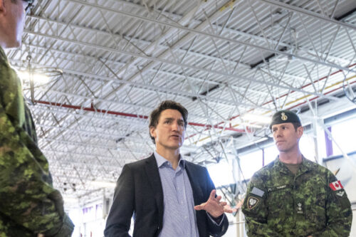 From left, General Steve Graham, Prime Minister Justin Trudeau and Colonel Ben Schmidt and Mp Bill Blair discuss the Alberta wildfires while meeting with members of the Canadian Armed Forces who are assisting in the Alberta wildfires, in Edmonton on Monday, May 15, 2023. Jason Franson/The Canadian Press. 