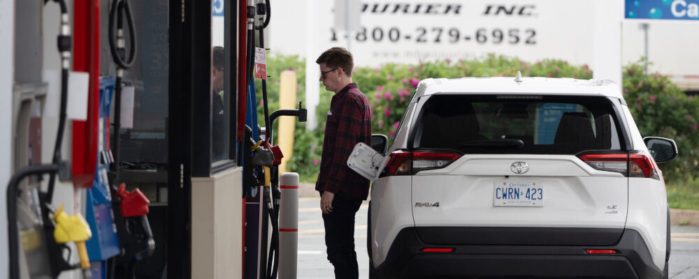 A motorist stands at the fuel pump to fill their tanks before the new federal carbon pricing takes effect at midnight in Halifax, Friday, June 30, 2023. Darren Calabrese/The Canadian Press. 