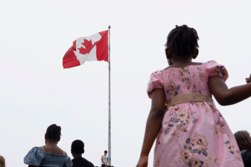 A Canadian flag is seen as people enjoy Canada Day festivities in Halifax on Saturday, July 1, 2023. Darren Calabrese/The Canadian Press. 