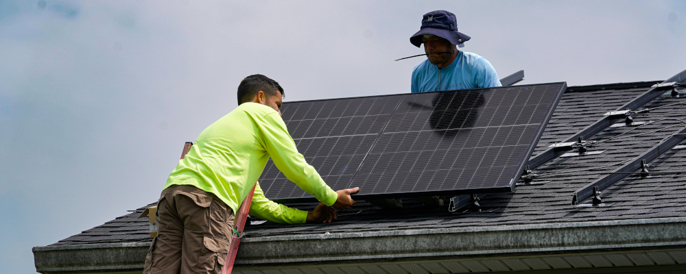 Brian Hoeppner, right, and Nicholas Hartnett, owner of Pure Power Solar, install a solar panel on the roof of a home in Frankfort, Ky., Monday, July 17, 2023. Michael Conroy/AP Photo. 
