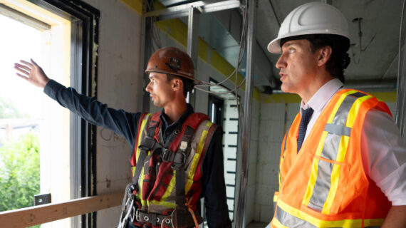 Prime Minister Justin Trudeau speaks with construction worker Patrick Van Dam during a visit to an apartment complex under construction in Hamilton, Ont., Monday, July 31, 2023. Peter Power/The Canadian Press. 