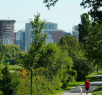 A new condo high-rise development is seen in the distance as people make their way along the Ottawa River in Ottawa on Wednesday, Aug. 23, 2023. Sean Kilpatrick/The Canadian Press. 