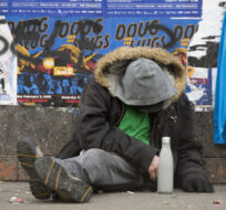 A man sits on a sidewalk along East Hastings Street in Vancouver's Downtown Eastside, Thursday, Feb 7, 2019. Jonathan Hayward/The Canadian Press. 
