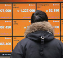 In this Tuesday, Jan. 16, 2018, file photo, a man watches a screen showing the prices of bitcoin at a virtual currency exchange office in Seoul, South Korea. Ahn Young-joon/AP Photo.