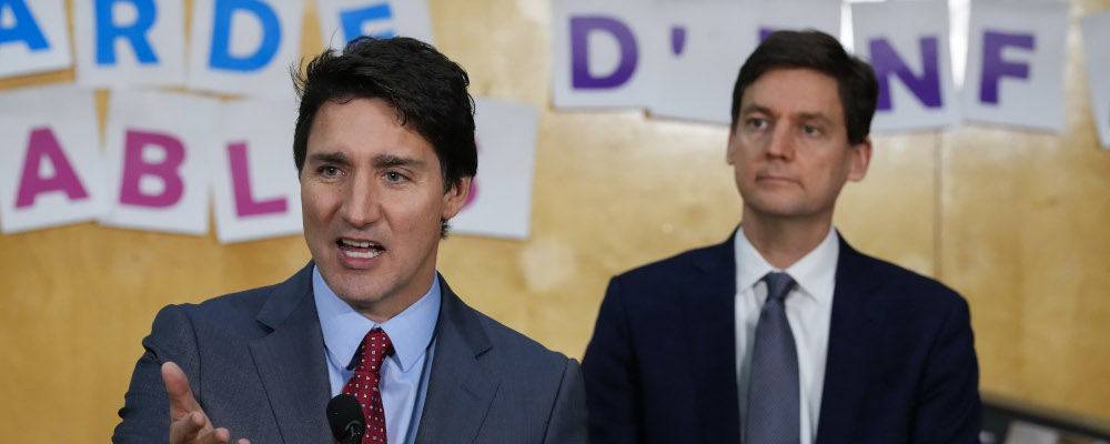 Prime Minister Justin Trudeau speaks as B.C. Premier David Eby, back right, listens during a child care announcement at the Richmond Jewish Day School, in Richmond, B.C., on Friday, December 2, 2022. Darryl Dyck/The Canadian Press. 