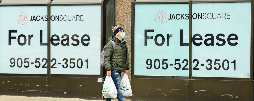 A man walks past office lease signs in downtown Hamilton, Ont., on Thursday, March 18, 2021. Nathan Denette/The Canadian Press. 