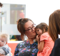 Prime Minister Justin Trudeau talks to Brenda Gunn and her daughter Holly and other parents at the YMWCA daycare in Winnipeg, Friday, March  3, 2023. John Woods/The Canadian Press. 