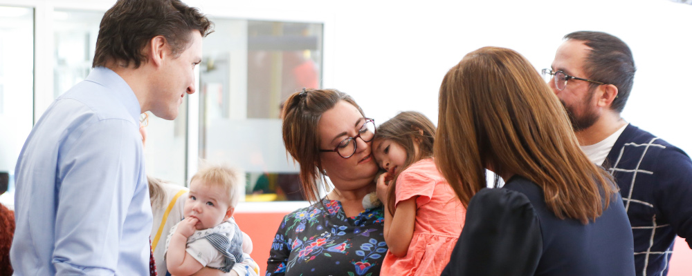 Prime Minister Justin Trudeau talks to Brenda Gunn and her daughter Holly and other parents at the YMWCA daycare in Winnipeg, Friday, March  3, 2023. John Woods/The Canadian Press. 