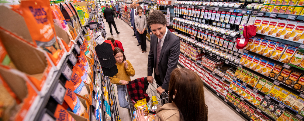 Prime Minister Justin Trudeau speaks with families in a Co-Op grocery store during an organized media event in Regina, Thursday, April 13, 2023. Liam Richards/The Canadian Press. 