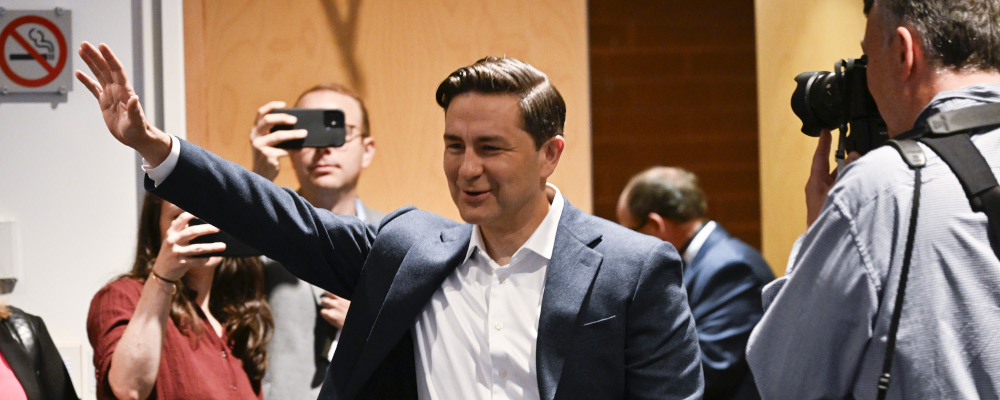 Conservative Leader Pierre Poilievre waves as he enters a caucus meeting in Quebec City on Sept. 7, 2023. Jacques Boissinot/The Canadian Press.