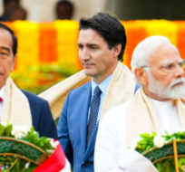 Prime Minister Justin Trudeau walks past  Indian Prime Minister Narendra Modi, right, and President of Indonesia Joko Widodo as they take part in a wreath laying ceremony at Raj Ghat (Mahatma Gandhi's cremation site) during the G20 Summit in New Delhi, India on Sunday, Sept. 10, 2023. Sean Kilpatrick/The Canadian Press. 