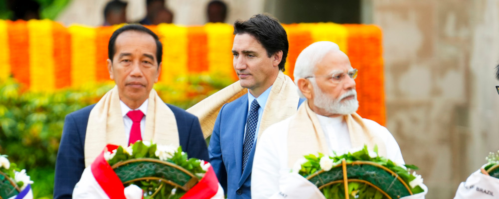 Prime Minister Justin Trudeau walks past  Indian Prime Minister Narendra Modi, right, and President of Indonesia Joko Widodo as they take part in a wreath laying ceremony at Raj Ghat (Mahatma Gandhi's cremation site) during the G20 Summit in New Delhi, India on Sunday, Sept. 10, 2023. Sean Kilpatrick/The Canadian Press. 