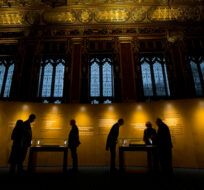 In this Thursday, Feb. 5, 2015 file photo, people look at the four surviving original parchment engrossments of the 1215 Magna Carta as they are displayed to mark the 800th anniversary of the sealing of Magna Carta at Runnymede in 1215, in the Queen's Robing Room at the Houses of Parliament in London. Matt Dunham/AP Photo. 